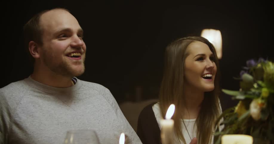 A man and a woman look at each other and then laugh