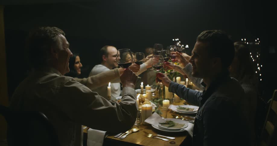 A family all have a toast at a dining room table