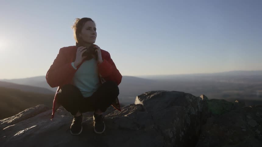 Woman takes off her headphones to enjoy scenic view