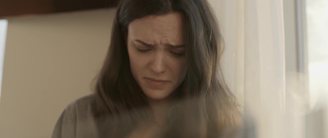 An unhappy woman with her head bowed