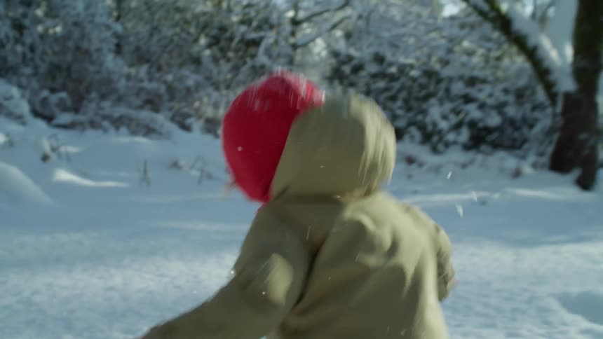 A child running and falling in the snow