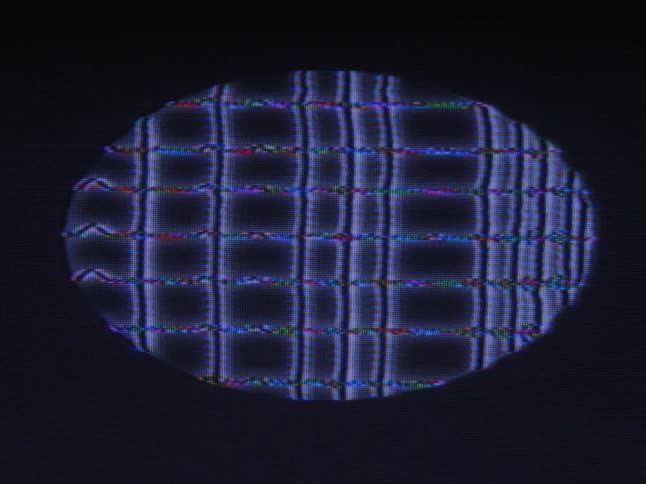 An oval digital display of blue grid lines waving and shifting