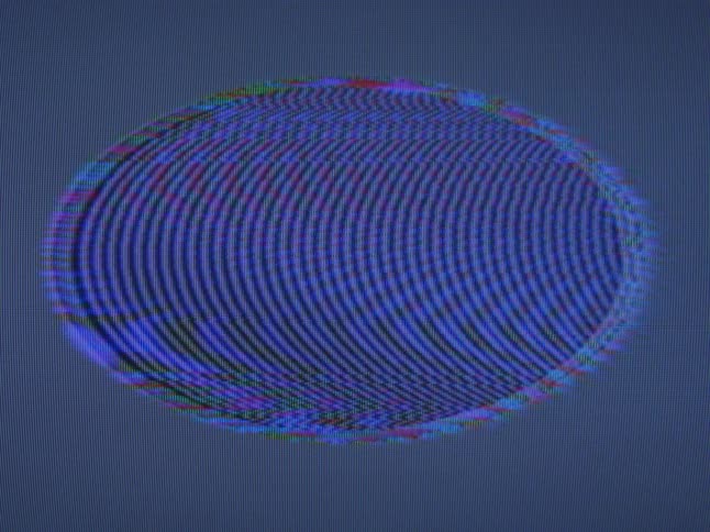 Blue lines and waves in the shape of an oval on a digital display