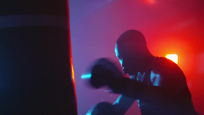 A man boxing in a dark room