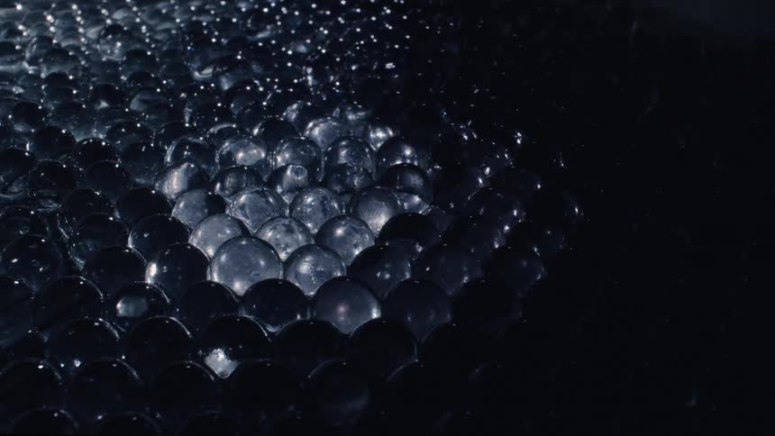 Marbles sit in rows in a diamond formation with gradient gray tones