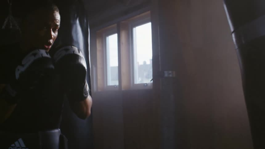 A man is punching the heavy bag