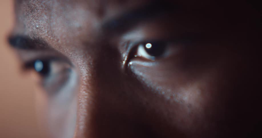 A man grimaces and scrunches his eyes in alarm and pain