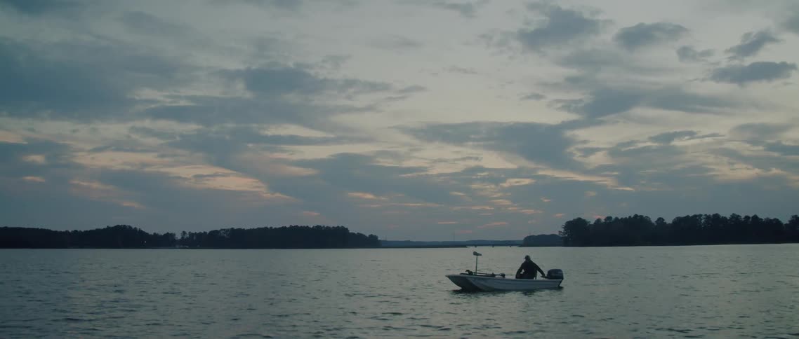 A man sits in his boat in the lake