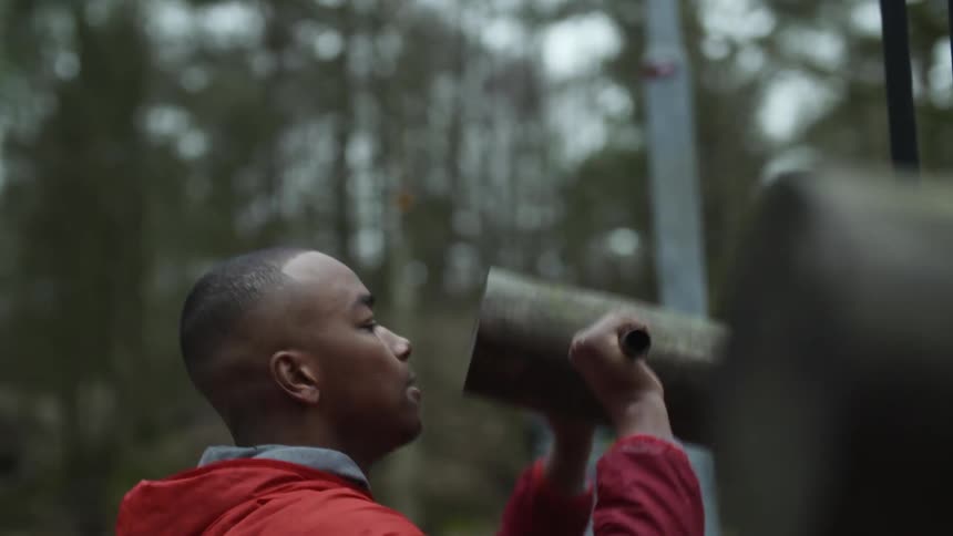 Man with red jacket works out in the woods
