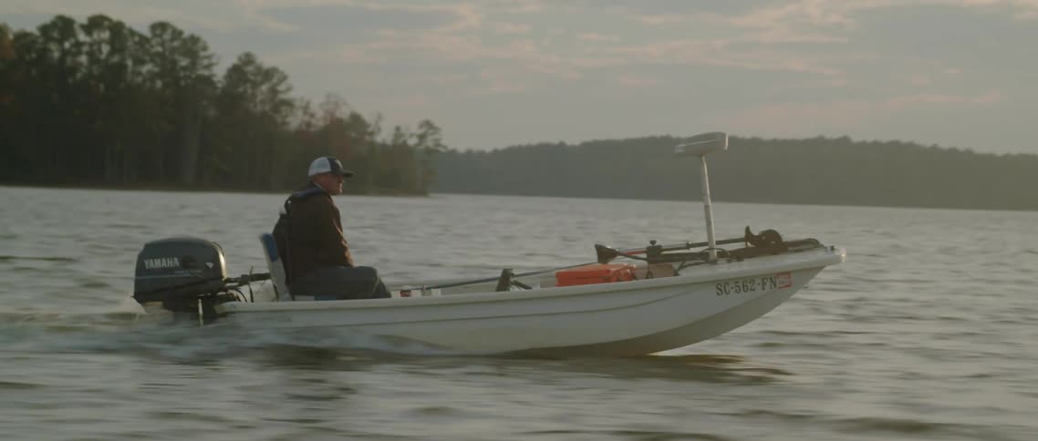 A man is driving his motor boat