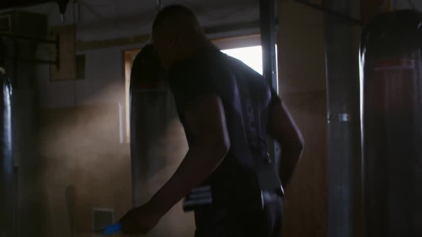 A man is jumping rope in a gym