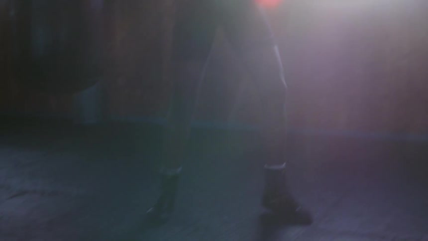 A man throws punches at a bag as he boxes