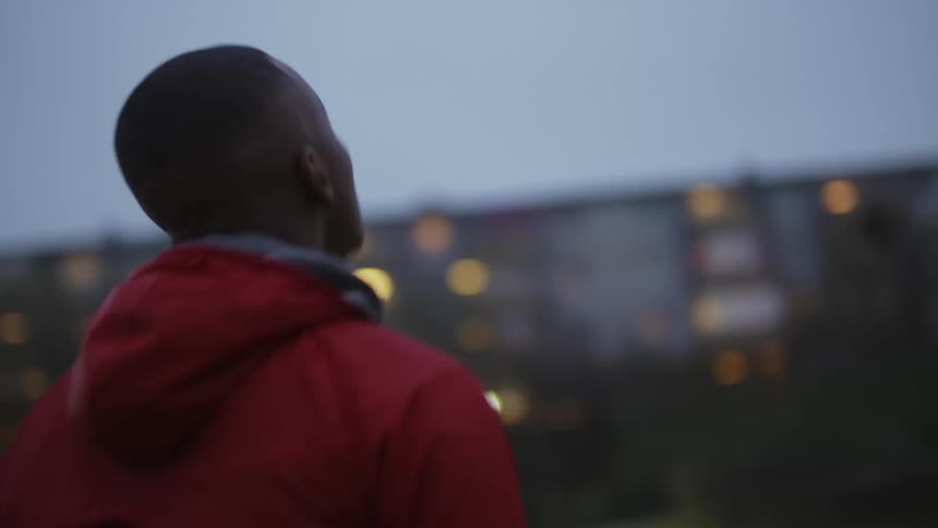 A man jogging in place moving his neck and head as he loosens up