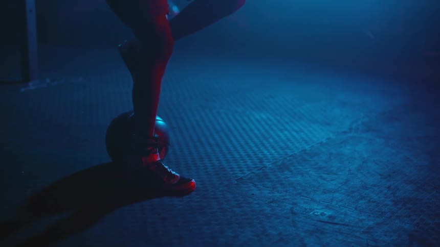 A person is kicking a ball in the gym