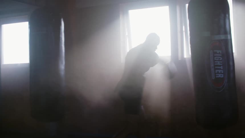 A man is punching the heavy bag