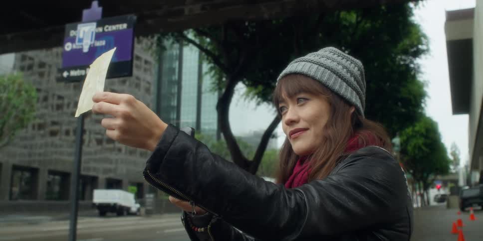 A woman looks at something outside