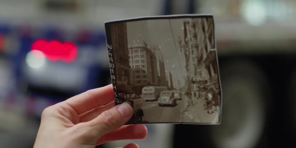 A person lifts a photo up