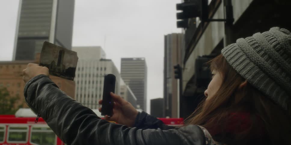 A woman takes a photograph of a photograph