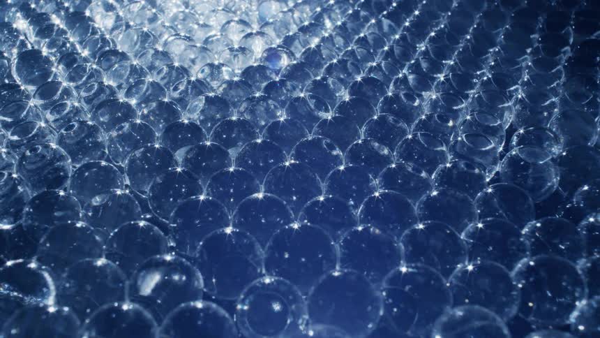 A bright light shines on plastic circles stacked together