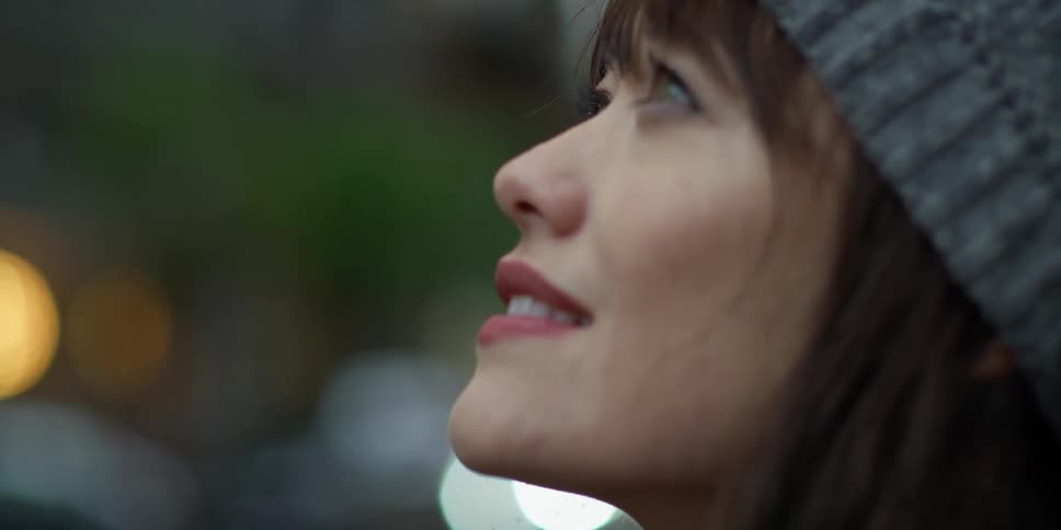 A woman is looking around outside