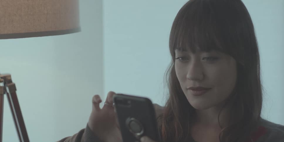 A woman is using her cell phone
