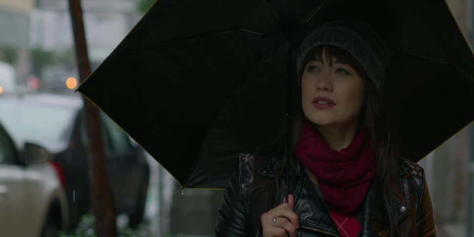 A woman walks in the rain in the city