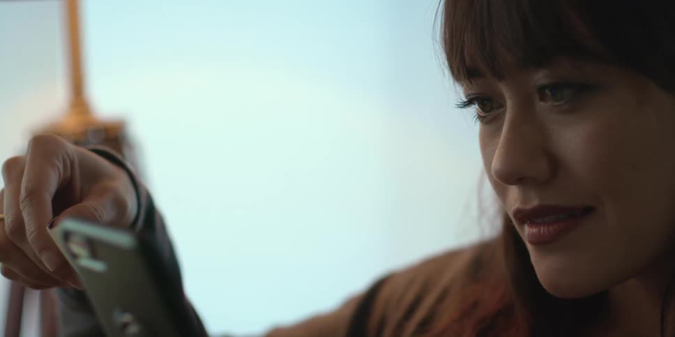 A woman is holding her cell phone