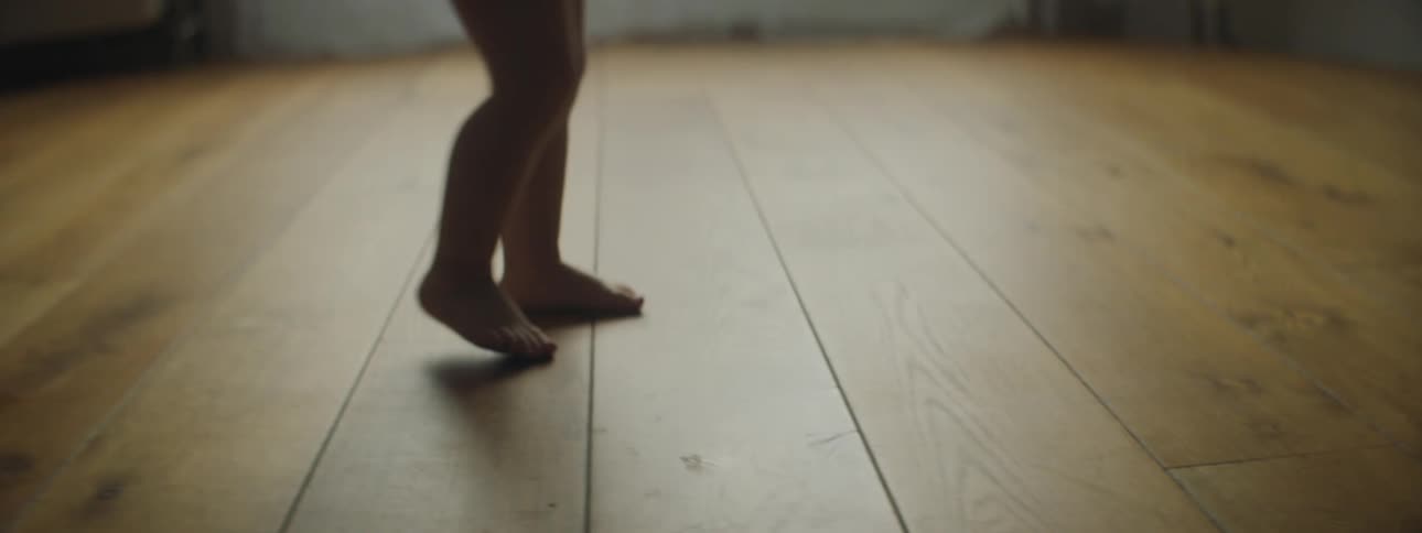 A baby taking a few steps at home
