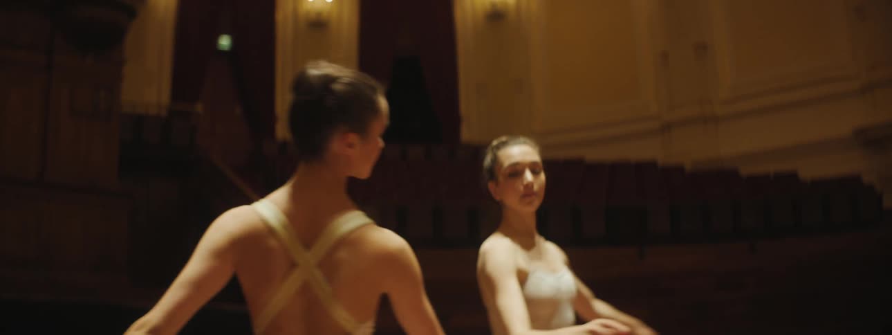 Two women are doing ballet indoors