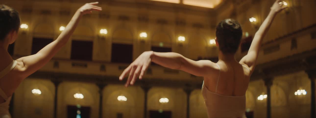 Two women are doing ballet in a room