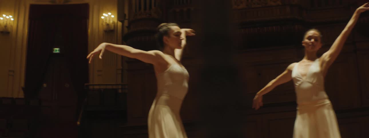 Two women are dancing in a room