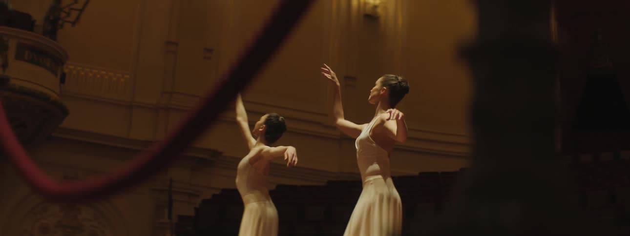 Two women are dancing in a room