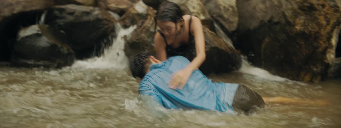 Two teenagers play around in the water