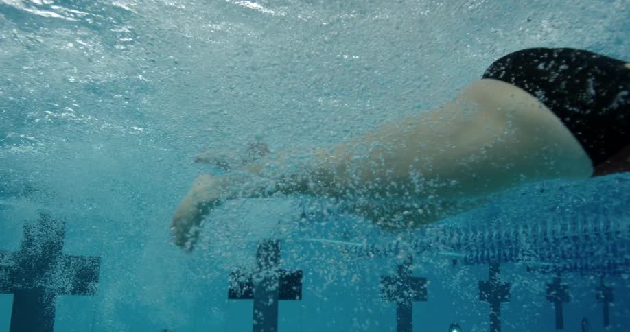 A woman swims through pool water