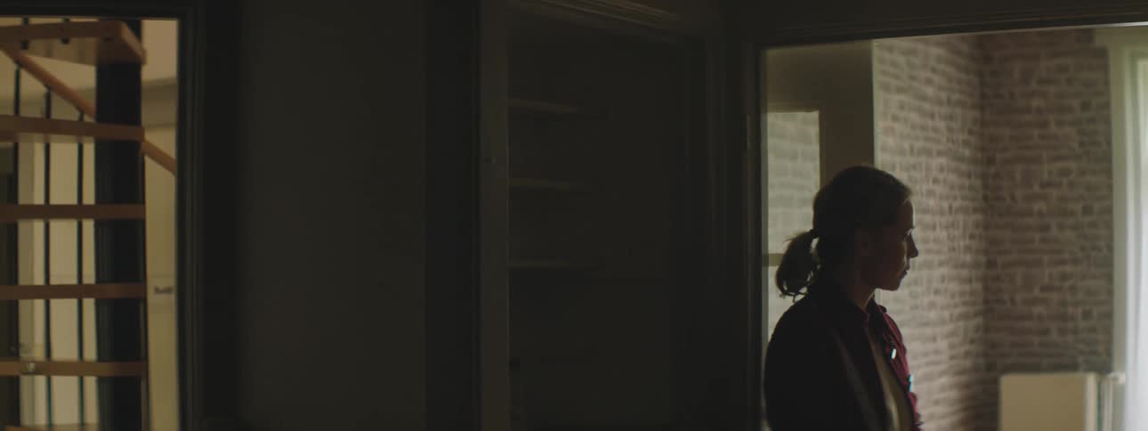 A woman is standing in a building during the day