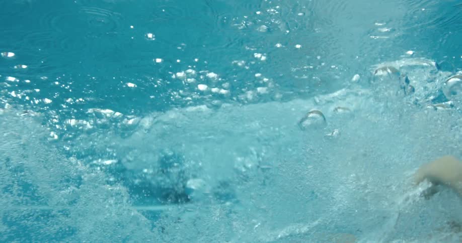 A woman dives into a swimming pool