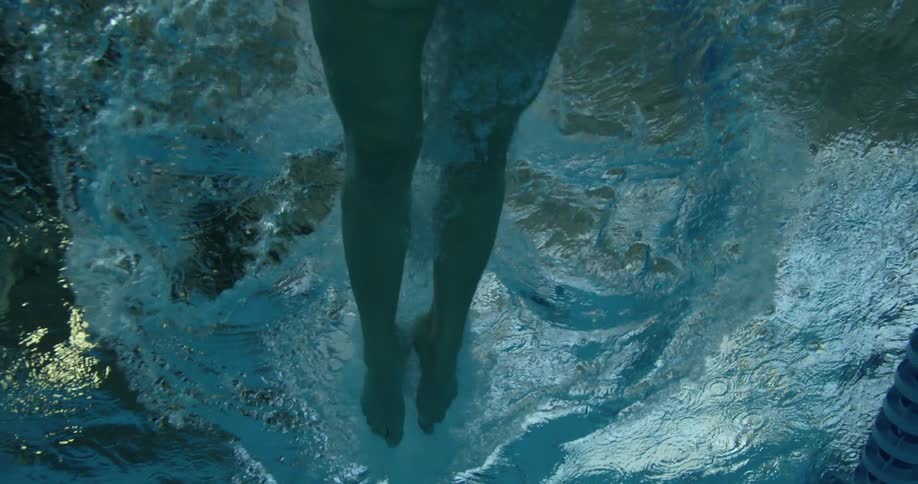 A woman dives into a pool