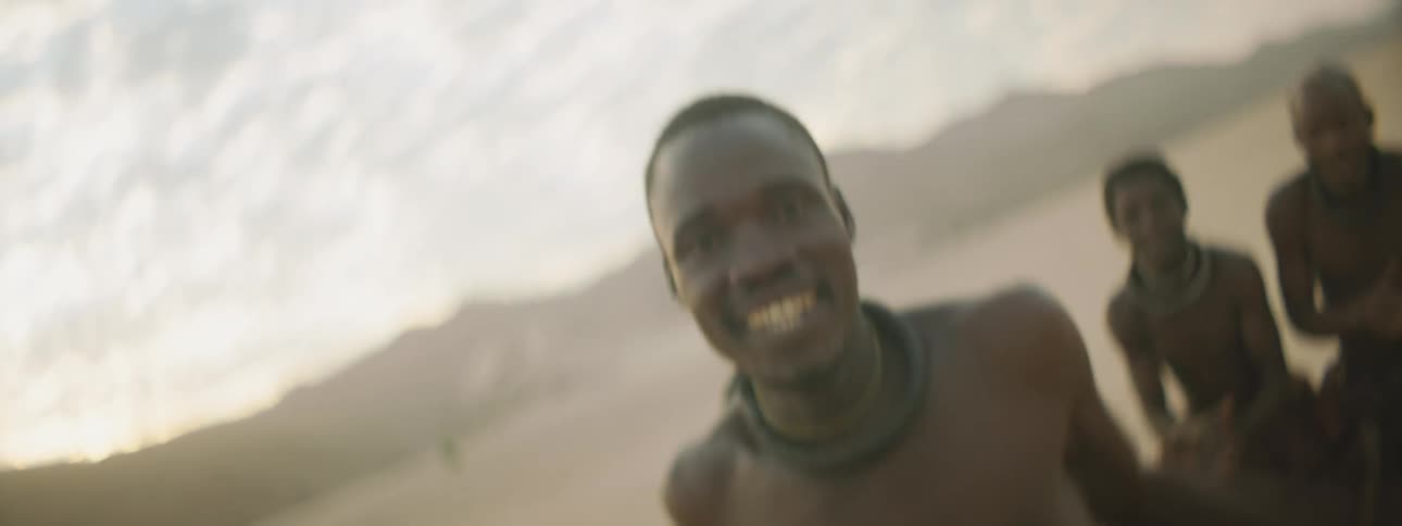 A tribe dance and cheer in the desert
