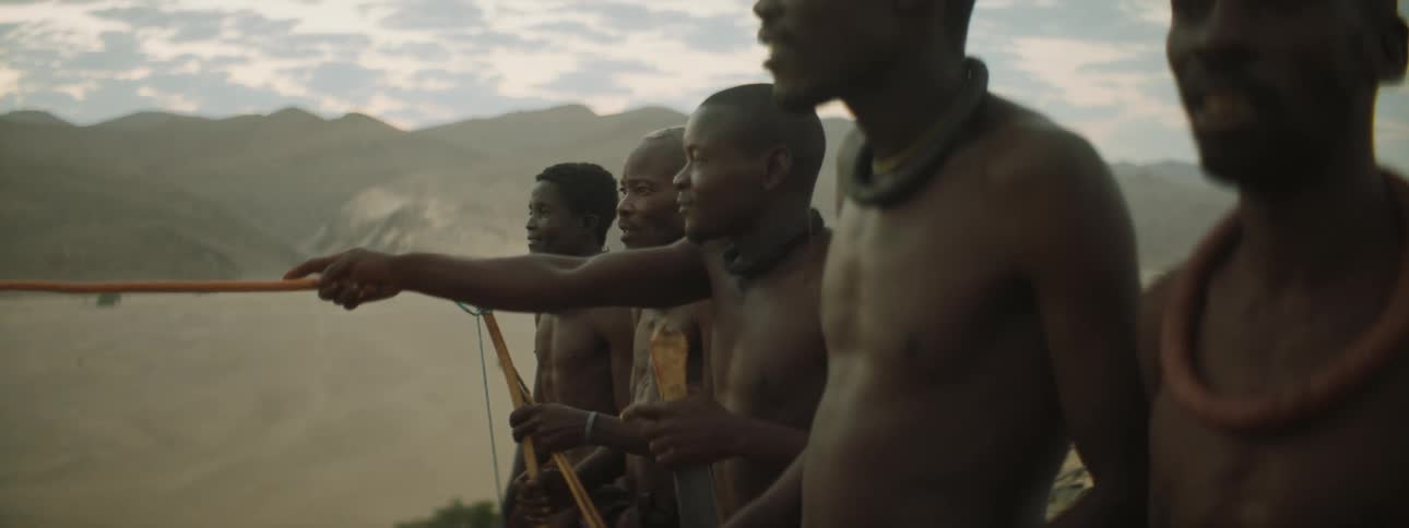 Group of young men looking at something in the desert