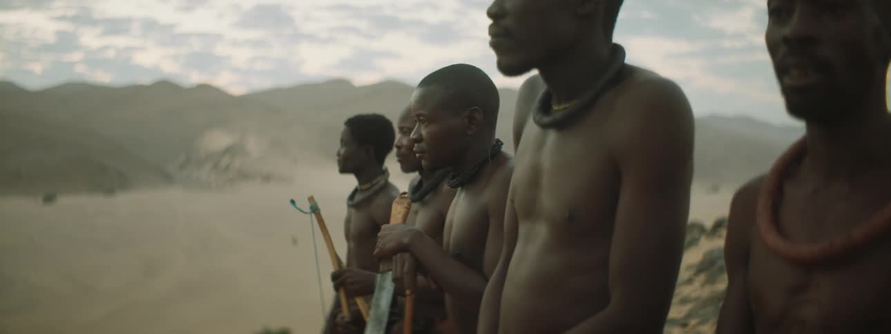 A group of villagers stand in a line