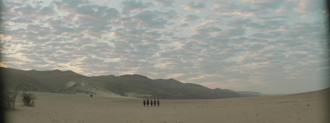 A group of people hike in the desert