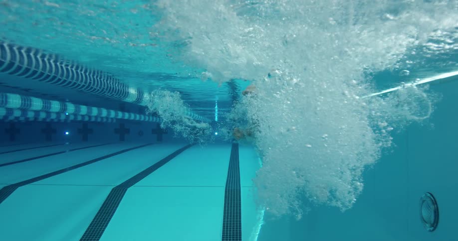 A woman dives into a swimming pool
