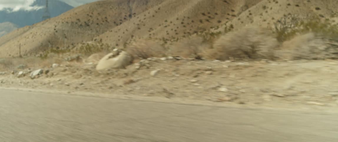 A road through an arid countryside during the day