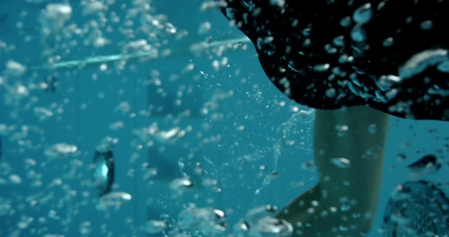 A swimmer swims through pool water