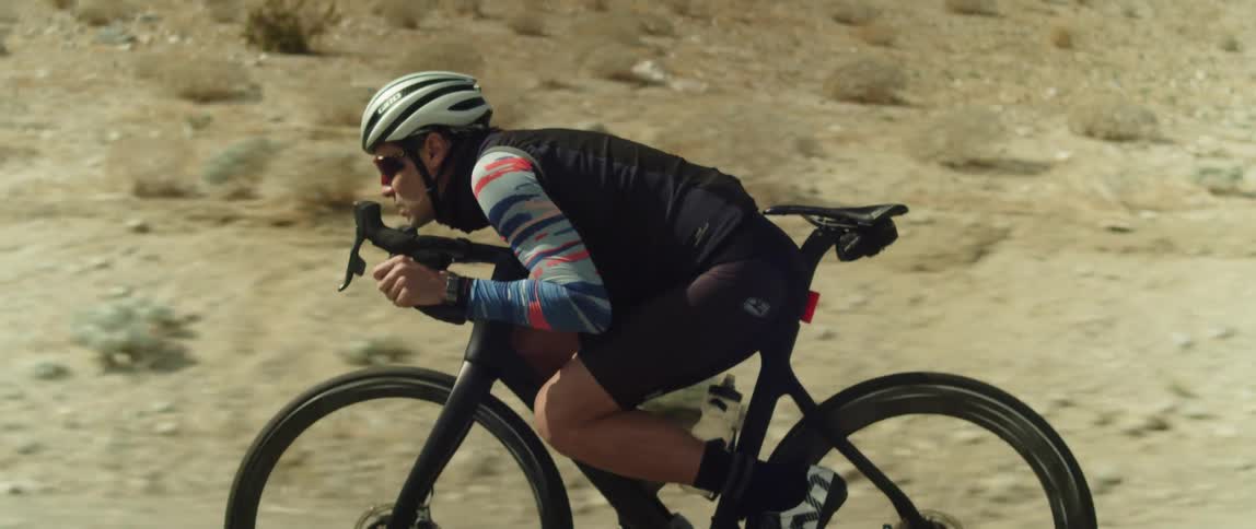A man in a helmet riding a bicycle outdoors
