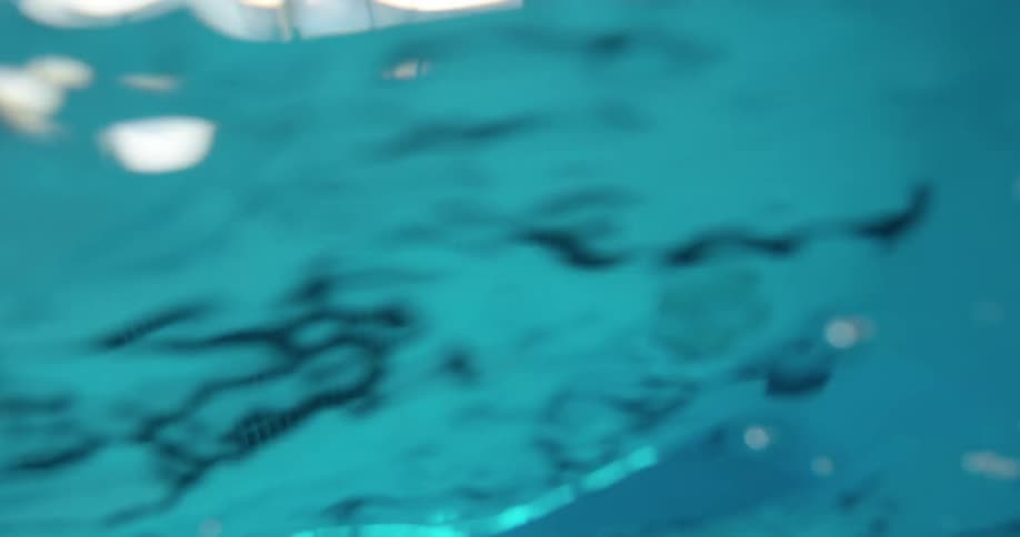 Windows are reflected in the water of a swimming pool