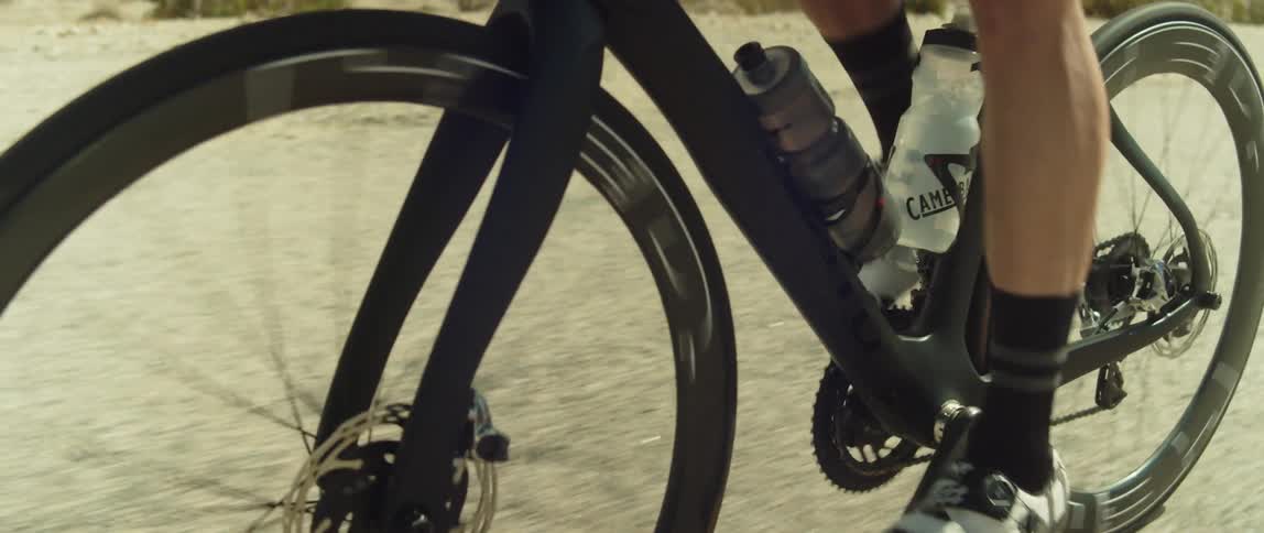 A man is having a leisurely bike ride in the desert
