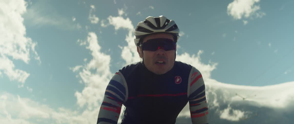 A person is riding a bicycle outdoors at dusk
