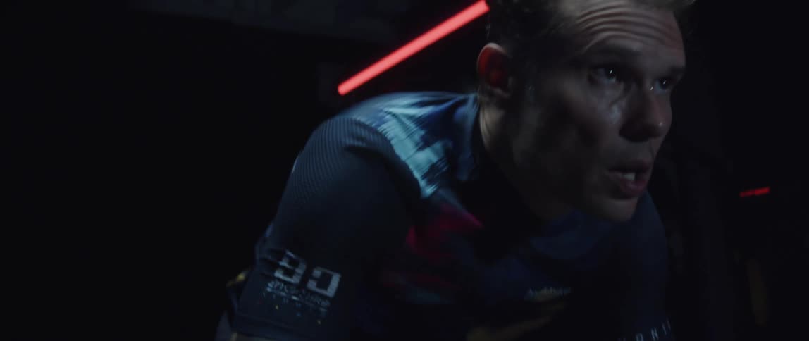 A man sweating and breathing heavily while riding a stationary bike