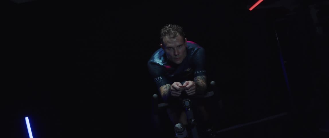 A man is working out on a bicycle machine
